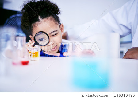 Child, science and chemistry with a magnifying glass in laboratory for a test or research. African kid student curious for scientist, education or learning chemical experiment in class with magnifier Child, science and chemistry with a magnifying glass in laboratory for a test or research. African kid student curious for scientist, education or learning chemical experiment in class with magnifier 136319489
