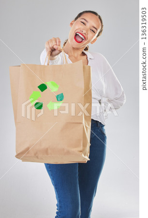 Recycling, environment and happy woman with bag, carbon footprint and sustainability with shopping on white background. Environmental, retail and eco friendly, female person excited in studio Recycling, environment and happy woman with bag, carbon footprint and sustainability with shopping on white background. Environmental, retail and eco friendly, female person excited in studio 136319503