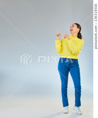 Space, happy and presentation with woman and pointing in studio for show, advertising and idea. Announcement, promotion and deal with person on grey background for opportunity, offer and news mockup Space, happy and presentation with woman and pointing in studio for show, advertising and idea. Announcement, promotion and deal with person on grey background for opportunity, offer and news mockup 136319508