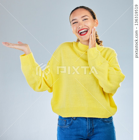 Space, smile and presentation with portrait of woman in studio for show, advertising and idea. Announcement, promotion and deal with person on grey background for opportunity, offer and news 136319519