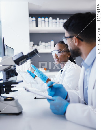 Scientist man, woman and tablet for microscope analysis, dna or virus for pharmaceutical company in lab. Teamwork, medical research and digital touchscreen for data, info or pharma study for wellness Scientist man, woman and tablet for microscope analysis, dna or virus for pharmaceutical company in lab. Teamwork, medical research and digital touchscreen for data, info or pharma study for wellness 136319589