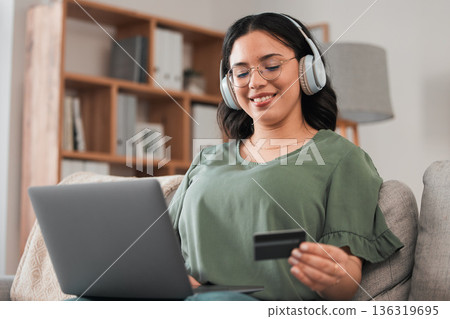 Woman, credit card and headphones for laptop online shopping, e learning and fintech payment on sofa. Student or person for music streaming subscribe, banking services and home education on computer Woman, credit card and headphones for laptop online shopping, e learning and fintech payment on sofa. Student or person for music streaming subscribe, banking services and home education on computer 136319695