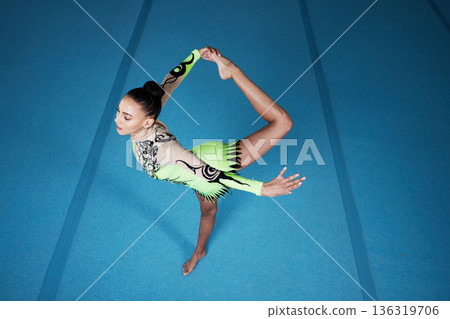 Woman, balance and gymnastics competition with exercise, action and body with performance in arena. Female gymnast, event and athlete with fitness, flexibility and sports, top view, acrobat in gym 136319706