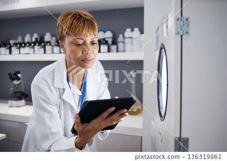 Scientist, tablet and serious woman with incubator in laboratory, research or online study. Technology, medical professional and doctor of science on internet for reading, healthcare and email app. Scientist, tablet and serious woman with incubator in laboratory, research or online study. Technology, medical professional and doctor of science on internet for reading, healthcare and email app. 136319861