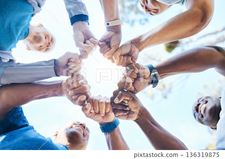 Fist bump, fitness and group of people for teamwork, collaboration and community, team building and support. Mission, workout goals and hands, power and solidarity sign of person outdoor from below 136319875
