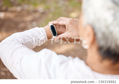 Senior woman, check smart watch and fitness in park to monitor speed, heart or progress. Outdoor, female runner and iot clock for time, training or exercise with stopwatch, nature or summer sunshine Senior woman, check smart watch and fitness in park to monitor speed, heart or progress. Outdoor, female runner and iot clock for time, training or exercise with stopwatch, nature or summer sunshine 136319882