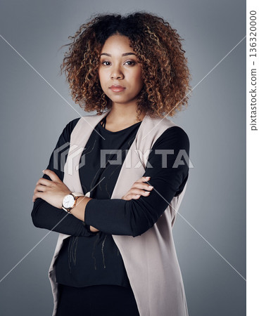 Confident, portrait of a businesswoman against a studio background for serious mindset. Empowerment or assertive, elegance or proud and female person pose for success with arms crossed in backdrop 136320000