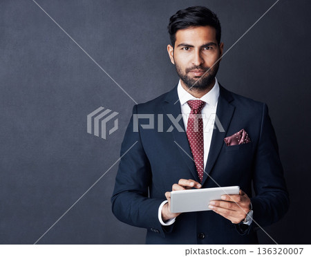 Portrait, businessman or tablet in studio, mockup space or background for trading, planning or research. Corporate trader, serious indian man in suit or digital technology of online stocks investment Portrait, businessman or tablet in studio, mockup space or background for trading, planning or research. Corporate trader, serious indian man in suit or digital technology of online stocks investment 136320007
