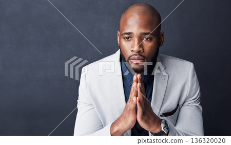 Praying, hands and business man with faith for career, job or opportunity, asking god for help and support. Corporate african person in prayer sign, religion and hope isolated on dark wall background Praying, hands and business man with faith for career, job or opportunity, asking god for help and support. Corporate african person in prayer sign, religion and hope isolated on dark wall background 136320020