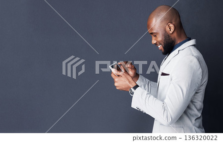 Tablet, search and business man isolated on a dark background with mockup for news, information or social media. Professional african person typing, reading or scroll on digital tech on a banner wall Tablet, search and business man isolated on a dark background with mockup for news, information or social media. Professional african person typing, reading or scroll on digital tech on a banner wall 136320022