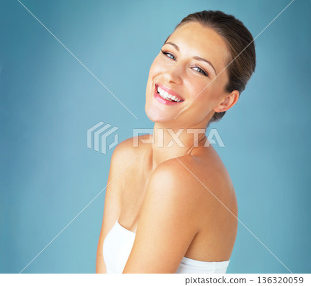 Skincare, beauty and smile, portrait of woman with natural dermatology and makeup on blue background. Happiness, skin care and wellness, happy face of model with cosmetics and facial glow on studio. 136320059