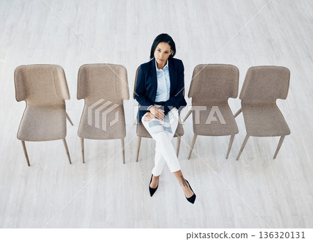 Business woman, waiting room and line of chairs for interview, hiring or recruitment at the office. Portrait of female person or employee sitting for appointment, meeting or career opportunity in row Business woman, waiting room and line of chairs for interview, hiring or recruitment at the office. Portrait of female person or employee sitting for appointment, meeting or career opportunity in row 136320131