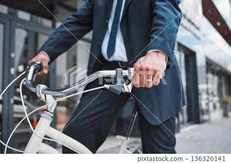 Hands, bicycle and businessman cycling in the city or riding for eco friendly travel, transport or commute to office, building or work. Man, driving and bike for carbon neutral footprint in town 136320141