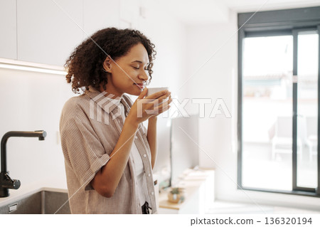 Sunny Window Provides Tranquil Atmosphere, Quiet Morning Scene With Relaxed Woman And Natural Light 136320194