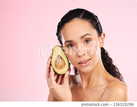 Face, skincare and serious woman with avocado in studio isolated on pink background mockup space. Portrait, natural cosmetic and model with fruit, food or nutrition for diet, vegan health or omega 3 Face, skincare and serious woman with avocado in studio isolated on pink background mockup space. Portrait, natural cosmetic and model with fruit, food or nutrition for diet, vegan health or omega 3 136320296