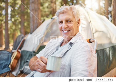 Camping, morning and portrait of senior man with coffee on holiday or vacation adventure in a forest or woods. Smile, happy and elderly person or camper relax by a tent in nature enjoying retirement 136320335
