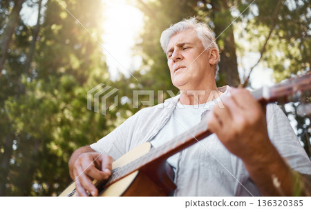 Senior man, guitar and woods for camping, music and relax with freedom, peace and outdoor in summer. Elderly guy, instrument and performance in forrest, sunshine and retirement on vacation in nature 136320385