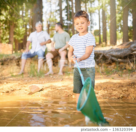Nature, fishing and child with net in river, fun and happy time on camping holiday weekend in woods. Lake, forest and relax in trees, boy catching fish in water on adventure on happy family vacation. Nature, fishing and child with net in river, fun and happy time on camping holiday weekend in woods. Lake, forest and relax in trees, boy catching fish in water on adventure on happy family vacation. 136320394