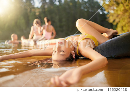 River, tube or woman in nature to relax with carefree fun, peace or holiday weekend in summer. Eyes closed, resting break or calm girl in lake water or dam to float outdoors on vacation trip 136320418