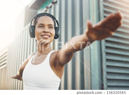 Fitness, exercise and woman stretching body in city or shipping dock listening to music, audio and track. Sports, healthy and female person outdoors for workout, training and warm up for running 136320565