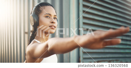Fitness, workout and woman stretching arms in city listening to music, audio and track. Sports, healthy body and female person outdoors with headphones for exercise, training and warm up for running 136320568