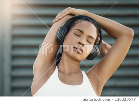 Stretching, city and woman with headphones, fitness or exercise with motivational podcast, relax or stress relief. Female person, athlete and girl with headset, streaming music or radio with wellness Stretching, city and woman with headphones, fitness or exercise with motivational podcast, relax or stress relief. Female person, athlete and girl with headset, streaming music or radio with wellness 136320577