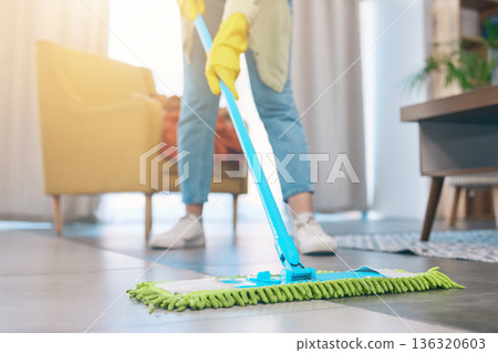 Woman, hands and cleaning floor with mop in living room for hygiene, bacteria or germ removal at home. Female person, housekeeper or maid in domestic service, dirt or dust for disinfection in house 136320603