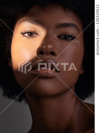 Shadow, portrait and black woman with beauty light, natural facial makeup and aesthetic skincare shine. Creative studio lighting, cosmetology and African person face with self care on grey background Shadow, portrait and black woman with beauty light, natural facial makeup and aesthetic skincare shine. Creative studio lighting, cosmetology and African person face with self care on grey background 136320612