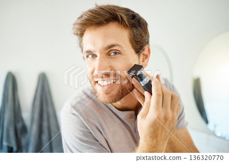 Portrait, happy man and shaving face with razor for hair removal, skincare routine and facial cleaning for self care at home. Young guy shave beard with blade, grooming and cosmetic tools in bathroom Portrait, happy man and shaving face with razor for hair removal, skincare routine and facial cleaning for self care at home. Young guy shave beard with blade, grooming and cosmetic tools in bathroom 136320770