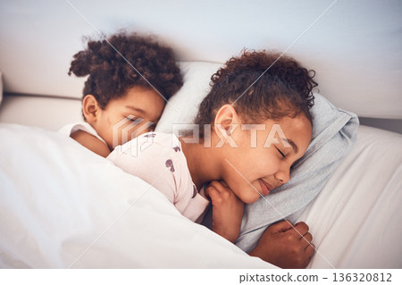 Girl, sleeping and children in bed in home with peace, comfort and rest with sisters, girls or friends together in bedroom. Kids, sleep and dream with happiness with pillow, blanket and duvet 136320812
