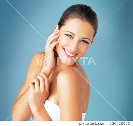 Skin care, beauty and smile, portrait of woman with dermatology and makeup on blue background. Happiness, skincare and wellness, happy face of model with cosmetics and facial glow on studio backdrop. Skin care, beauty and smile, portrait of woman with dermatology and makeup on blue background. Happiness, skincare and wellness, happy face of model with cosmetics and facial glow on studio backdrop. 136320960
