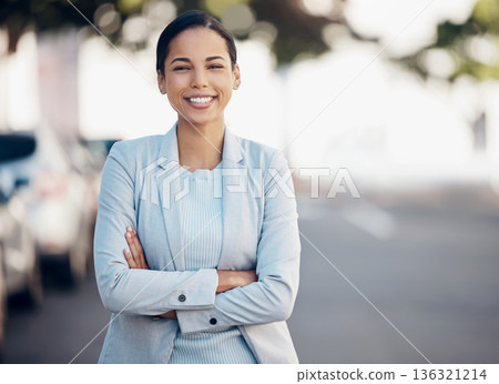Business woman, arms crossed and confidence portrait in a city with a smile from worker. Young female person, professional and urban commute with travel and happy employee on a street with bokeh 136321214
