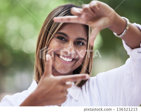 Portrait, smile and finger frame with a woman in nature, outdoor on a green background for creative photography. Face, photograph and hands with a happy young person in a park for a profile picture 136321215