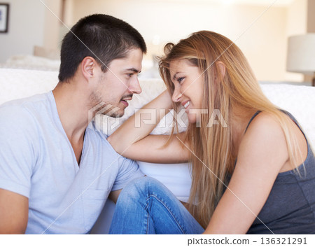 Talk, relax and couple bond on a sofa with conversation, gossip and hangout in their home together. Love, smile and happy woman with man in a living room with care, happy and soulmate connection 136321291