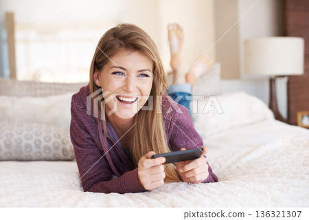 Teenager, happy and girl with games, using phone and relax in bedroom, smile with technology and esports. Young female person at home, gaming and mobile app with happiness, gen z and internet 136321307
