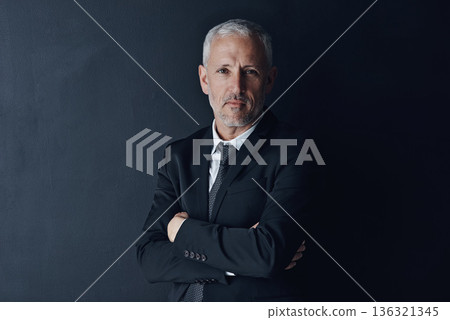Senior executive, business man and arms crossed with confidence in portrait and management on dark background. Male CEO, corporate director and suit with ambition, empowerment and career in studio 136321345