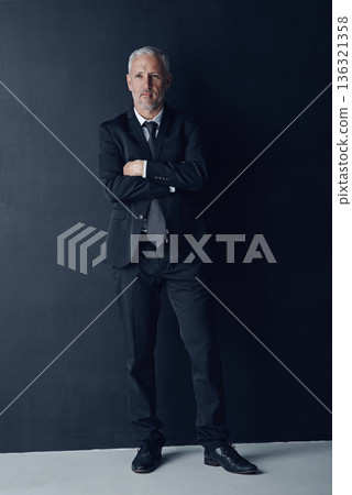 Arms crossed, senior and thinking with business man in studio for professional, corporate or manager. Boss, pride and confidence with male ceo on black background for executive and mockup space 136321358