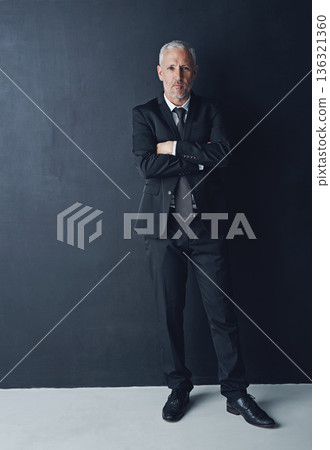 Portrait, serious and confident businessman with arms crossed in pride, lawyer or attorney on dark background. Boss, ceo and professional business owner, proud senior executive director at law firm. Portrait, serious and confident businessman with arms crossed in pride, lawyer or attorney on dark background. Boss, ceo and professional business owner, proud senior executive director at law firm. 136321360