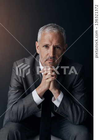 Boss, chair and serious portrait of lawyer, attorney or businessman with ceo on dark background in studio. Confidence, pride and legal business owner, proud senior executive director at law firm. 136321372