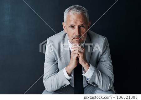 Serious portrait of senior attorney sitting with confidence, mockup space and dark background in studio. Pride, professional career ceo and executive lawyer man, mature businessman or law firm boss. 136321393