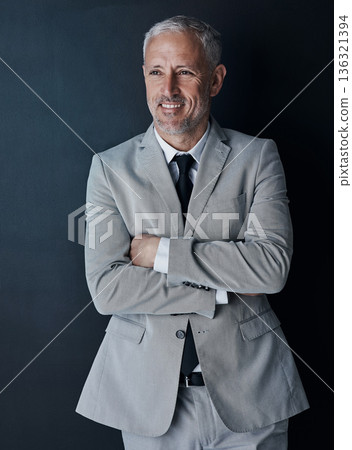 Senior businessman in suit, arms crossed and smile on dark background, happy lawyer in studio. Confidence, pride and professional career for executive ceo attorney, business owner and law firm boss. 136321394