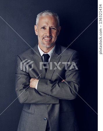 Smile, confidence and studio portrait of businessman in suit, arms crossed and pride on dark background. Boss, ceo and happy business owner with professional career, senior model executive with job. Smile, confidence and studio portrait of businessman in suit, arms crossed and pride on dark background. Boss, ceo and happy business owner with professional career, senior model executive with job. 136321434