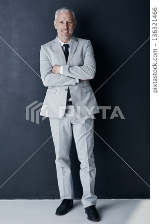 Studio portrait of mature man in suit, arms crossed and smile on dark background. Confidence, pride and professional career for happy executive businessman or senior business owner or successful ceo. Studio portrait of mature man in suit, arms crossed and smile on dark background. Confidence, pride and professional career for happy executive businessman or senior business owner or successful ceo. 136321466