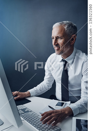 Typing accountant, computer and mature man in studio, working and isolated on a dark background mockup. Focus, writing and happy manager at desktop for reading email, research or business auditor. Typing accountant, computer and mature man in studio, working and isolated on a dark background mockup. Focus, writing and happy manager at desktop for reading email, research or business auditor. 136321560