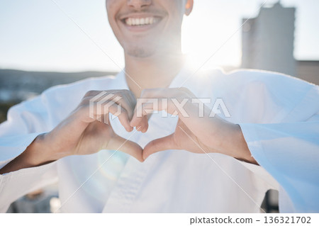 Heart in hands, karate and man in city for training, exercise and sports in morning outdoors. Happy, love emoji and male person with hand gesture for care in town for combat, martial arts and workout Heart in hands, karate and man in city for training, exercise and sports in morning outdoors. Happy, love emoji and male person with hand gesture for care in town for combat, martial arts and workout 136321702