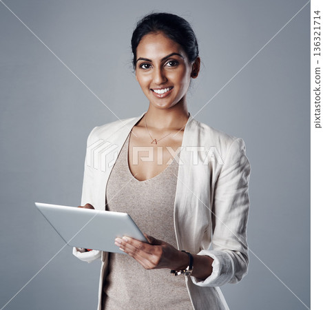 Technology, portrait of a businesswoman with tablet and against a studio background for connectivity. Online communication or social networking, happy and female person smile for data review Technology, portrait of a businesswoman with tablet and against a studio background for connectivity. Online communication or social networking, happy and female person smile for data review 136321714