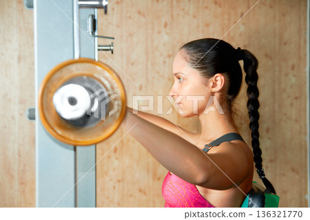 Profile, woman and barbell exercise in gym for power, workout and strong bodybuilding with focus. Serious female athlete, weights and fitness training for healthy muscles, sports and strength in club Profile, woman and barbell exercise in gym for power, workout and strong bodybuilding with focus. Serious female athlete, weights and fitness training for healthy muscles, sports and strength in club 136321770