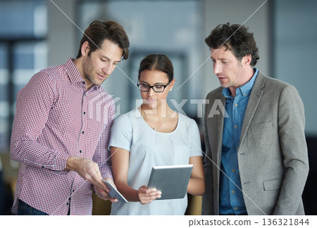 Team planning, tablet or business people with research in meeting for brainstorming together in office. Diversity, collaboration or employees working with technology or digital data in workplace 136321844