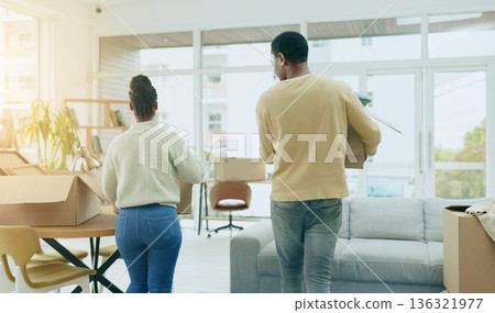 Black couple, box and moving in new home, real estate or mortgage loan together in living room renovation. Rear view of African man and woman with boxes for property, house investment or apartment Black couple, box and moving in new home, real estate or mortgage loan together in living room renovation. Rear view of African man and woman with boxes for property, house investment or apartment 136321977