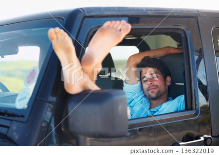 Travel, tired and man in a car, sleeping and road trip on a break, getaway and resting with transport. Male person, traveler and guy in a vehicle, fatigue and driver with dream, vacation and holiday 136322019